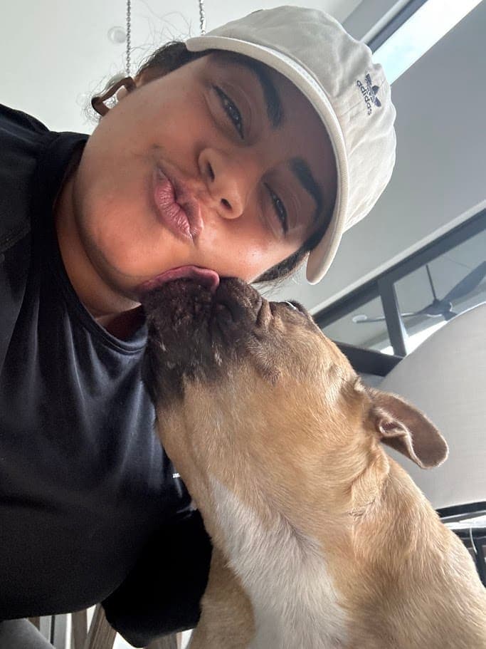 A dog giving Bianca a kiss
